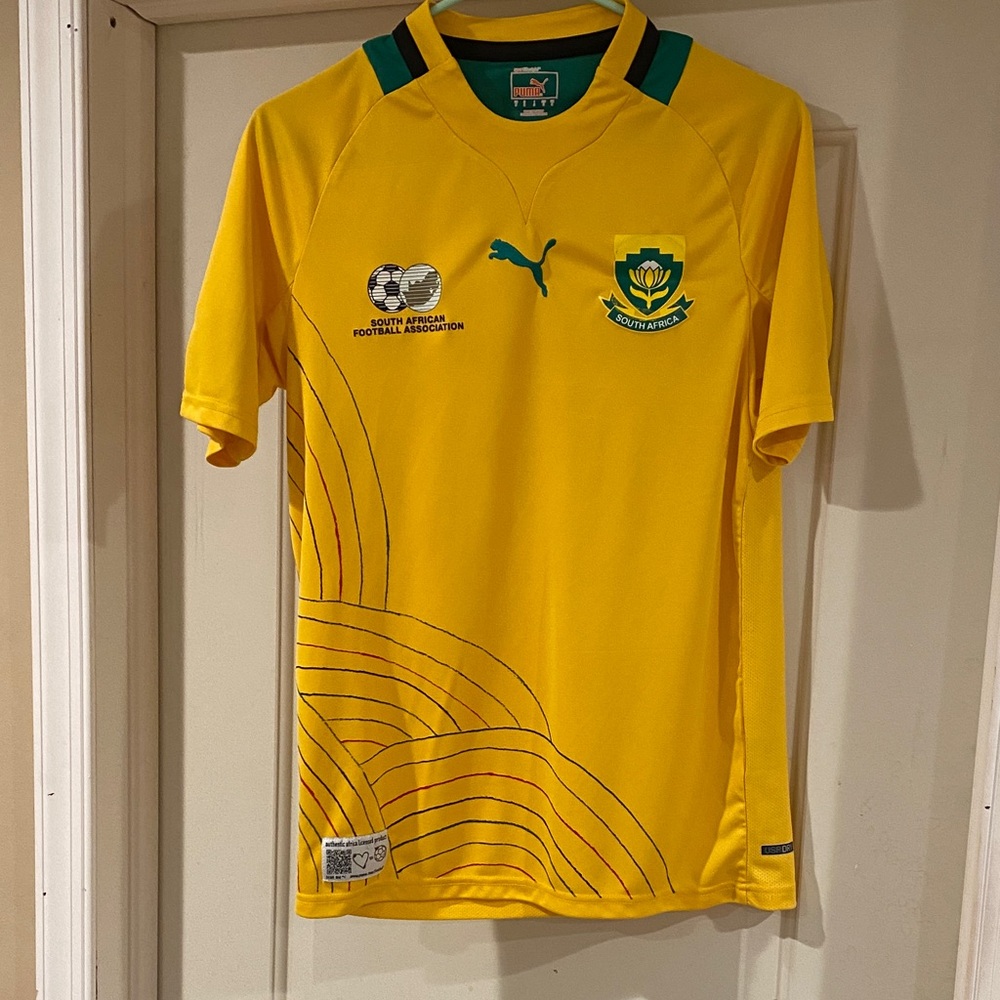 Puma Yellow short sleeve shirt with green & black strip on the collar size small
